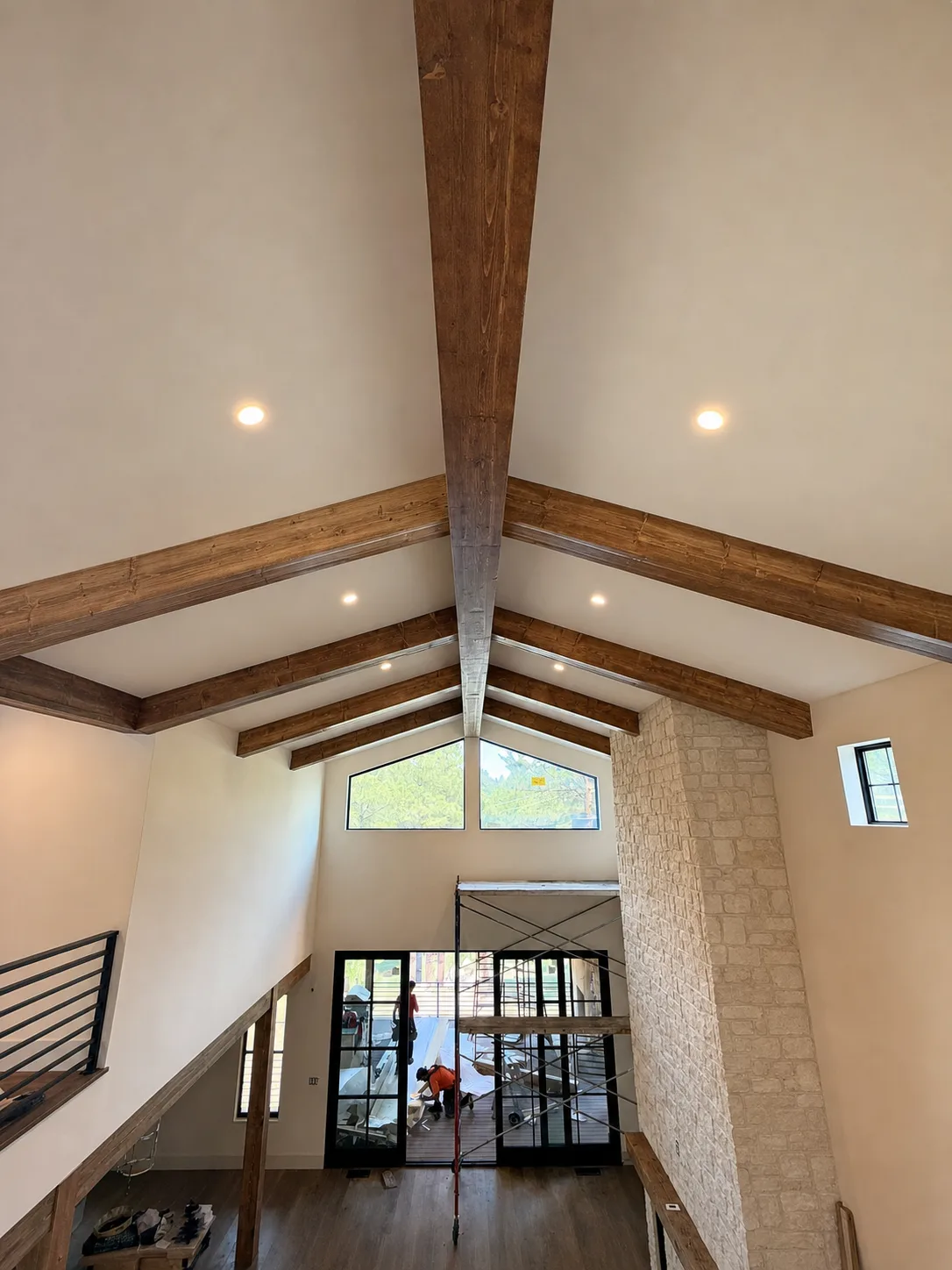 Vaulted great room with a ridge beam and exposed wood beams following the ceiling slopes