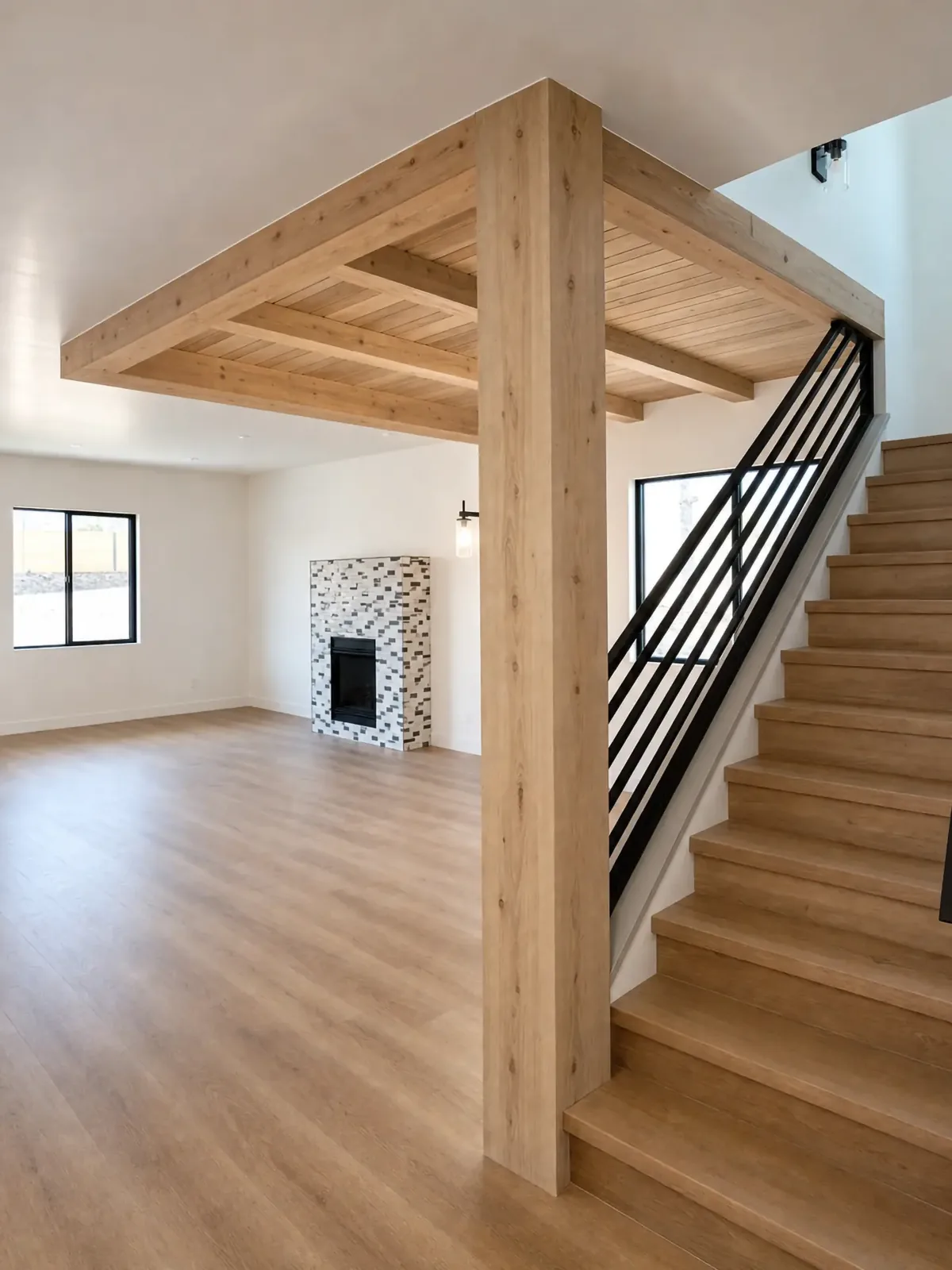 Wood beam and plank ceiling panel with a wrapped column beside an open stair with a black metal railing