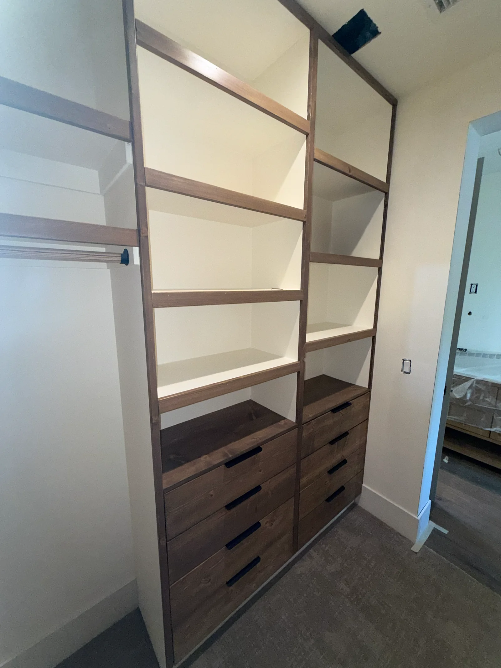 Custom reach-in closet cabinetry with adjustable shelving