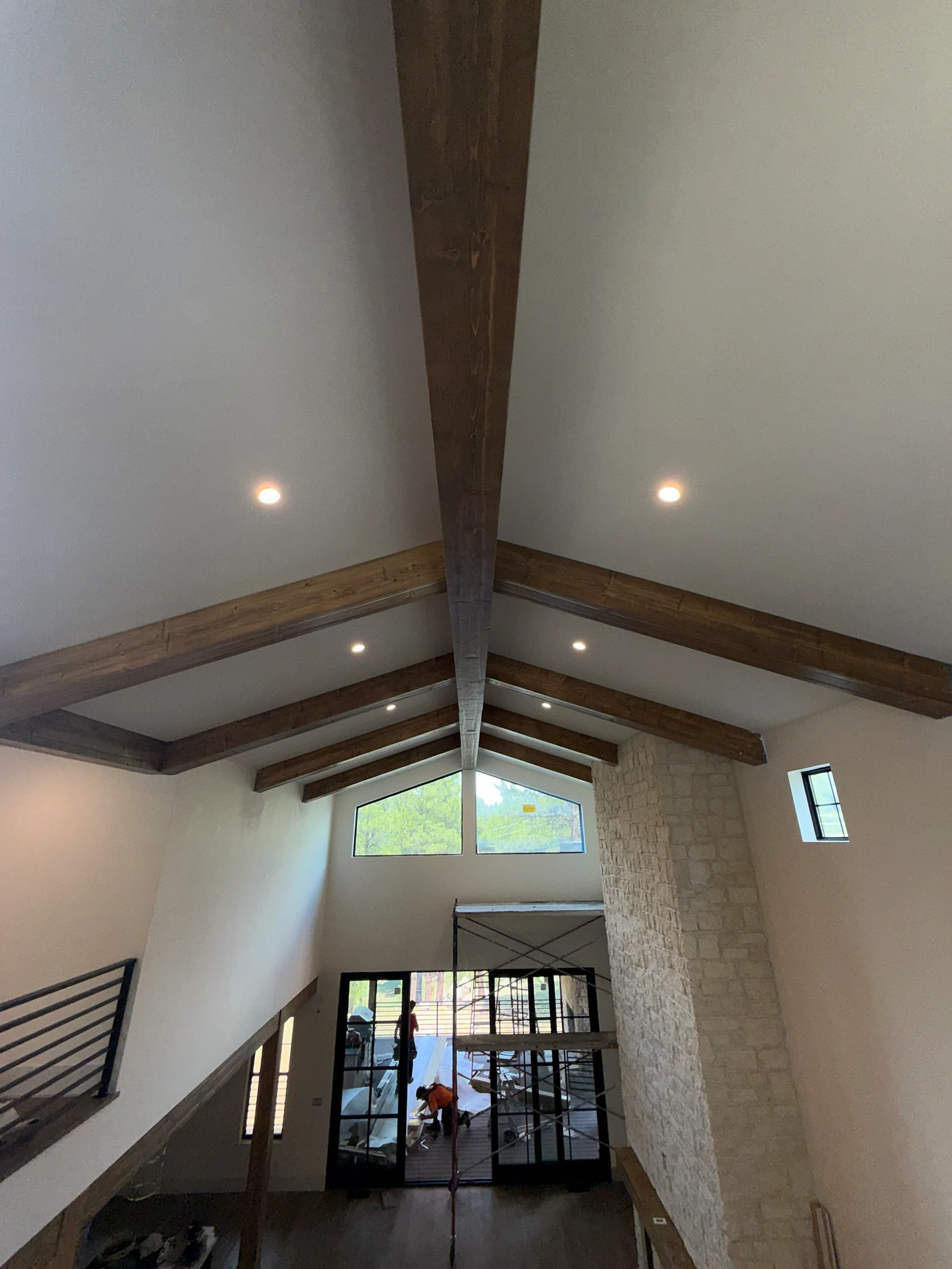 Cross-beam pattern of hand-hewn pine beams on a vaulted ceiling