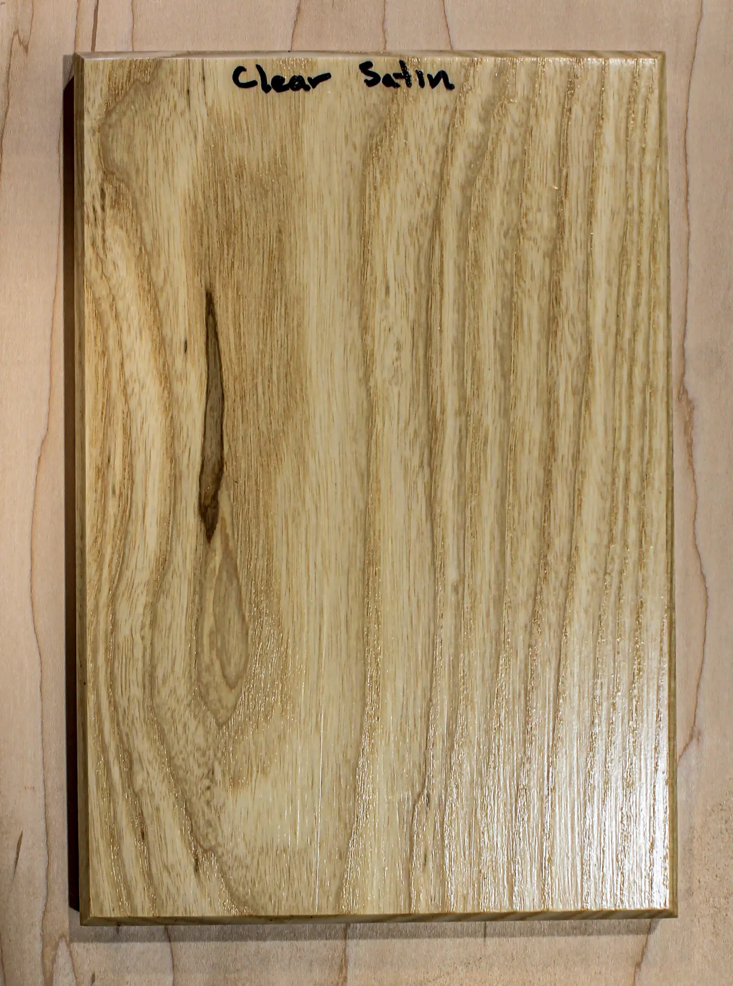 Finish sample board with a low-sheen clear topcoat, hand labeled "Clear Satin"
